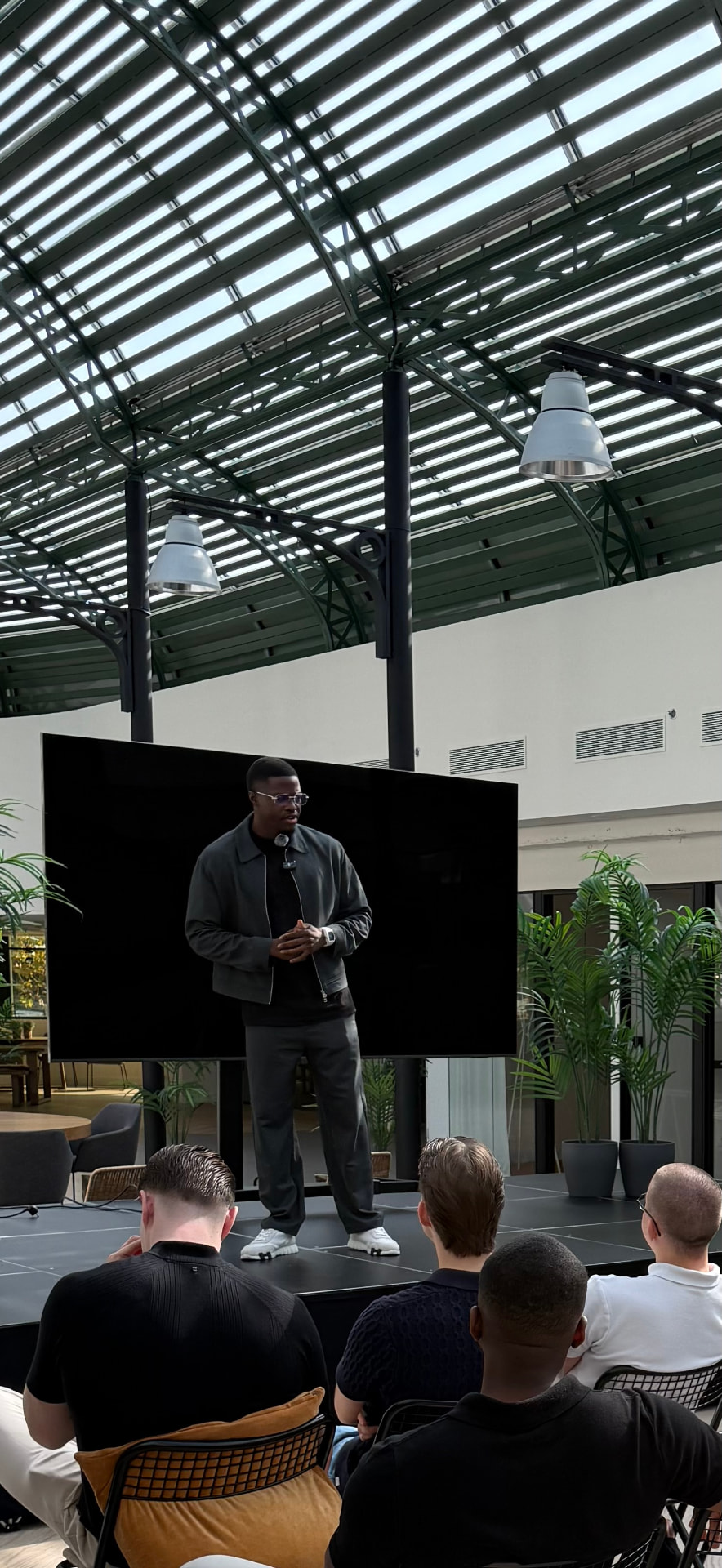 Joël Mbang speaking on stage